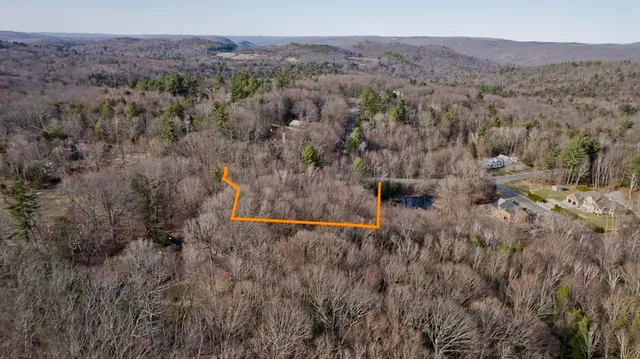 an aerial view of residential house and sandy dunes