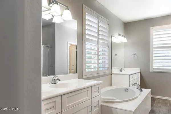 a bathroom with a sink double vanity and a mirror