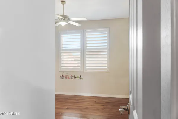 a view of empty room with wooden floor