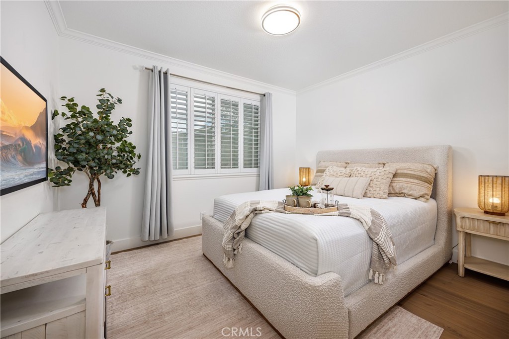 3 Tudor Way Ladera Ranch, CA 92694 - Photo 16 of 25 a bedroom with a large bed and a potted plant