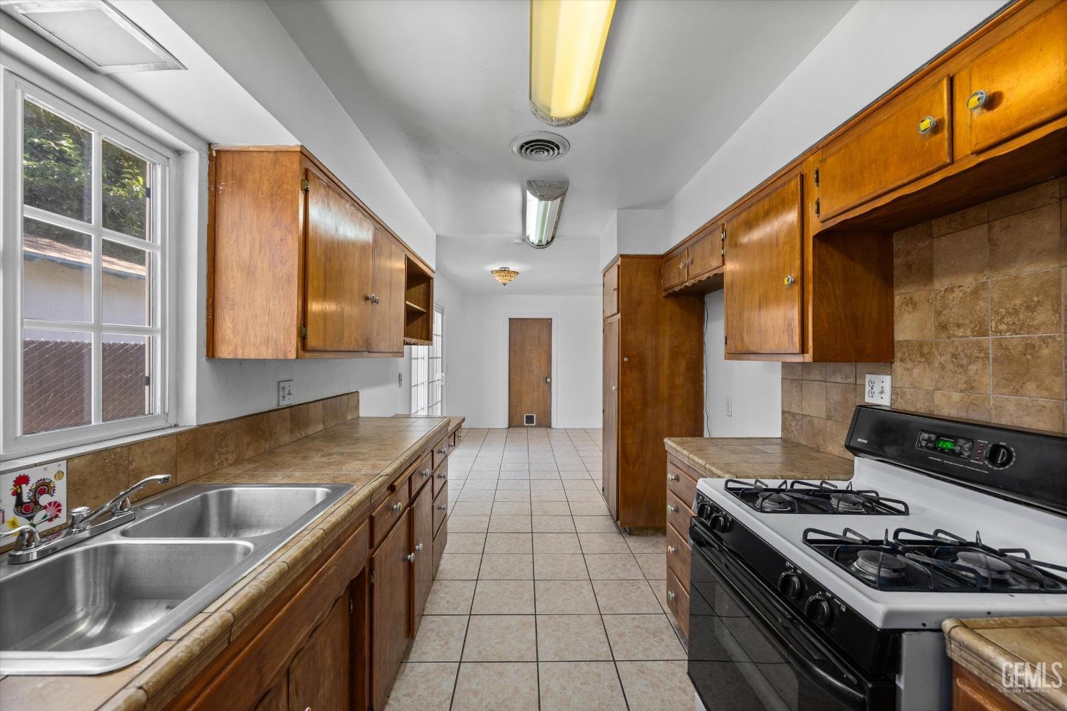 Undisclosed Address Bakersfield, CA 93309 - Photo 12 of 32 a kitchen with stainless steel appliances granite countertop a sink stove and cabinets