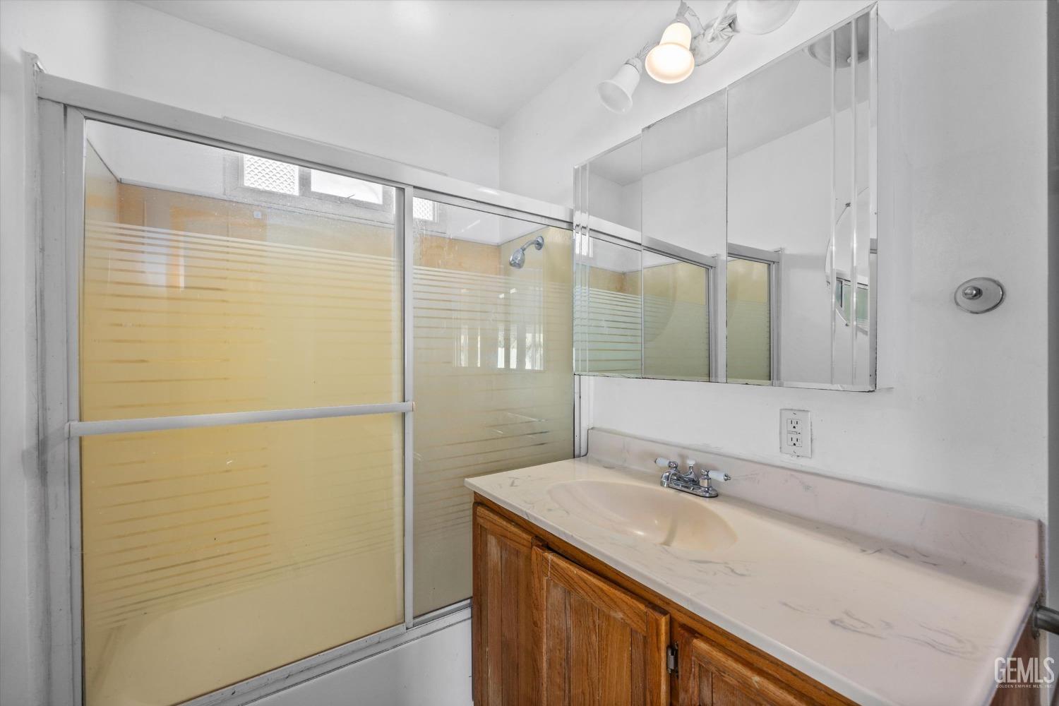 Undisclosed Address Bakersfield, CA 93309 - Photo 14 of 32 a bathroom with a sink and a mirror