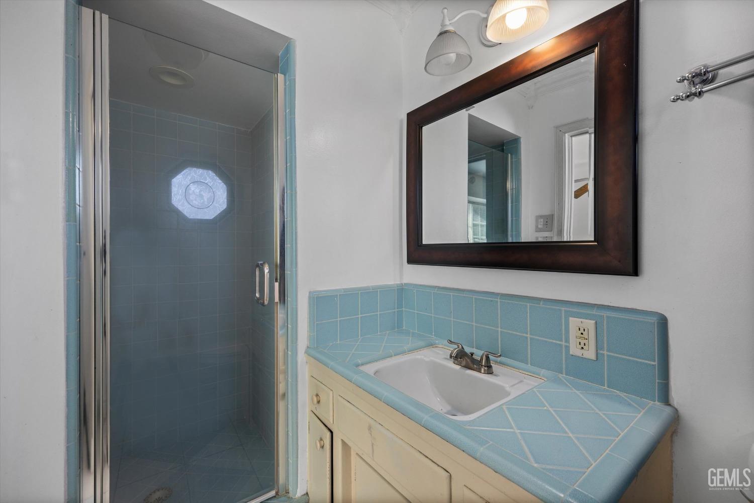 Undisclosed Address Bakersfield, CA 93309 - Photo 17 of 32 a bathroom with a sink vanity and mirror
