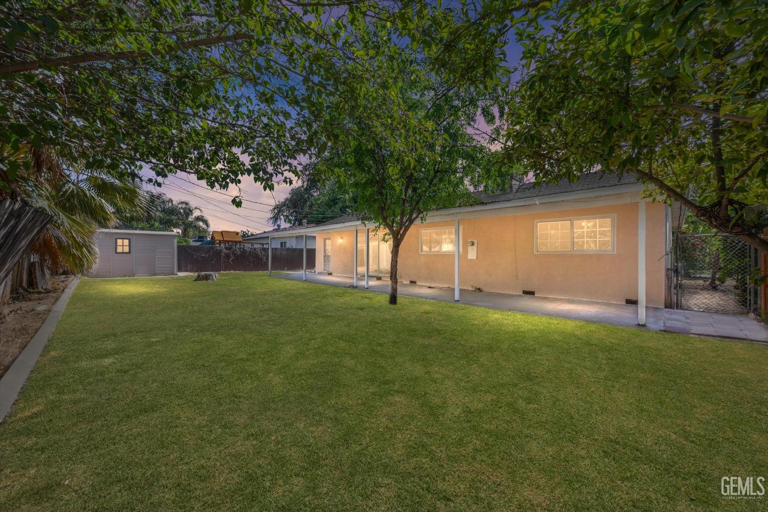 Undisclosed Address Bakersfield, CA 93309 - Photo 18 of 32 a front view of a house with a garden