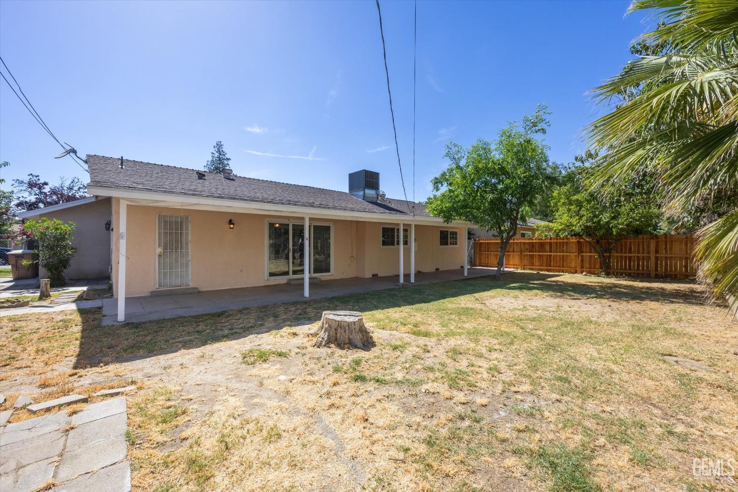 Undisclosed Address Bakersfield, CA 93309 - Photo 20 of 32 a front view of a house with a yard and garage