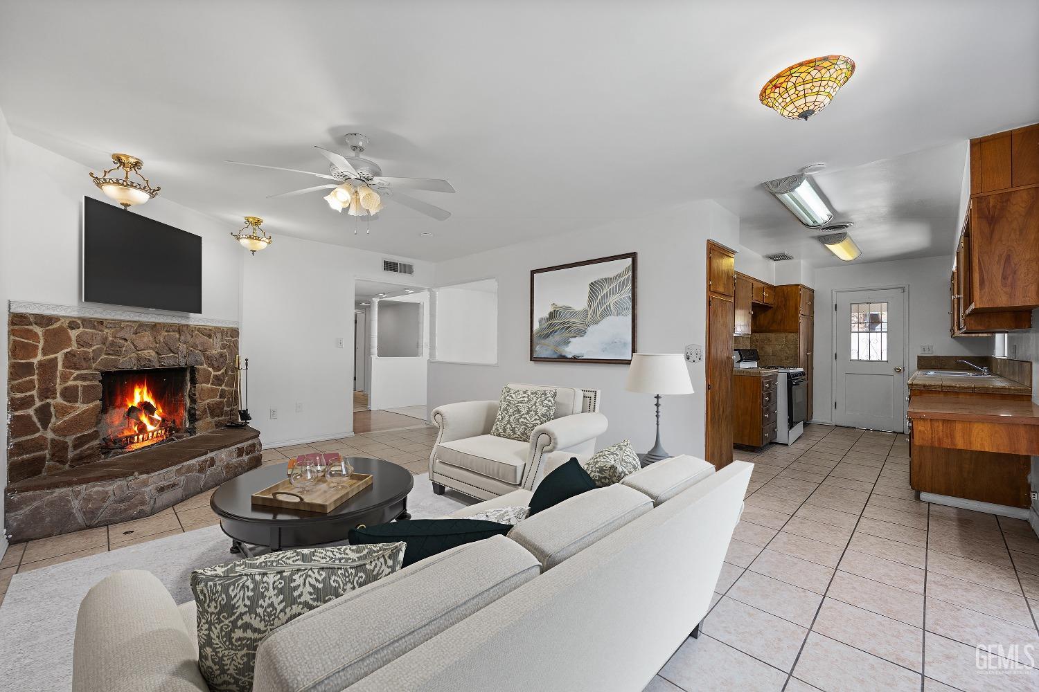 Undisclosed Address Bakersfield, CA 93309 - Photo 9 of 32 a living room with furniture and a fireplace