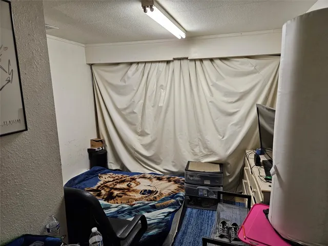 a kitchen with stainless steel appliances a stove sink refrigerator and cabinets