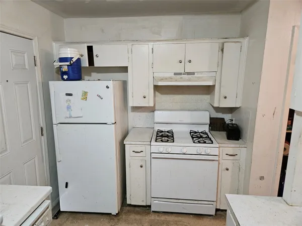 a kitchen with a sink cabinets and window