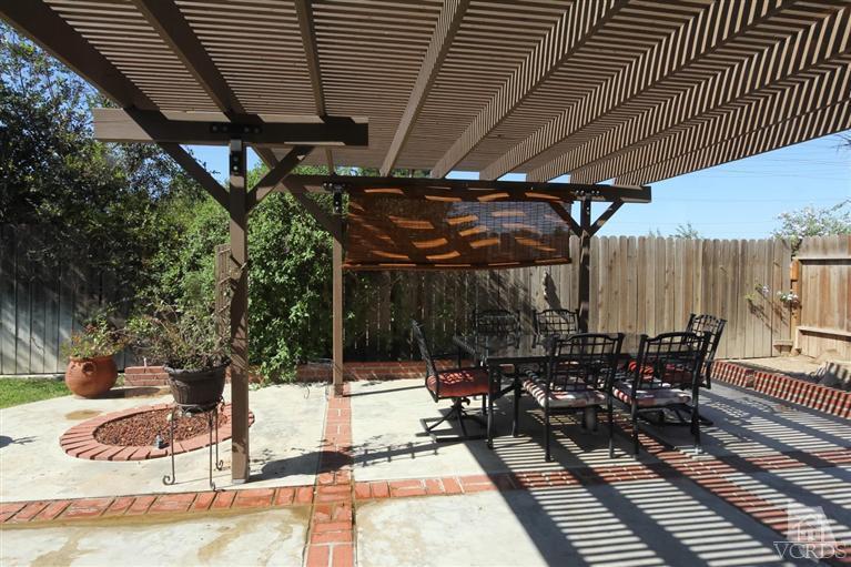 4757 Avedon Road Moorpark, CA 93021 - Photo 20 of 22 a view of a patio with table and chairs with wooden floor and fence