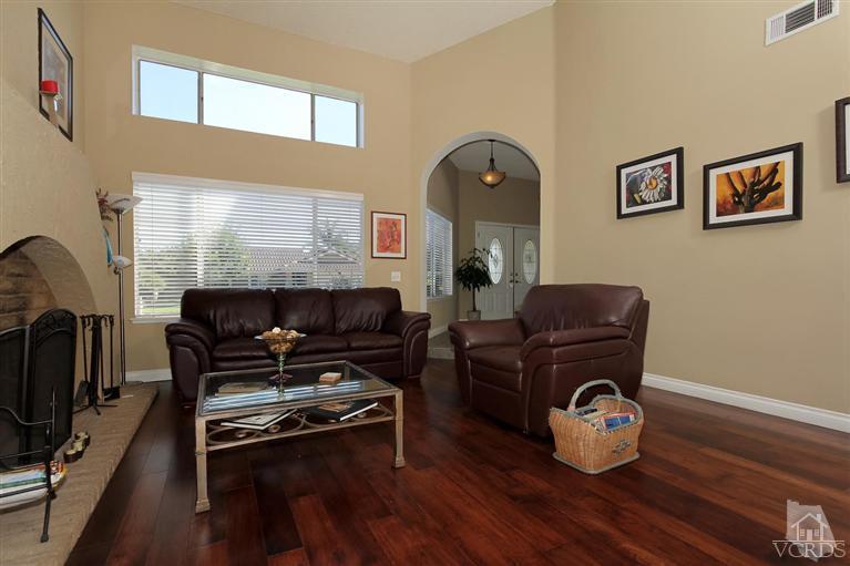 4757 Avedon Road Moorpark, CA 93021 - Photo 6 of 22 a living room with furniture a flat screen tv and a fireplace