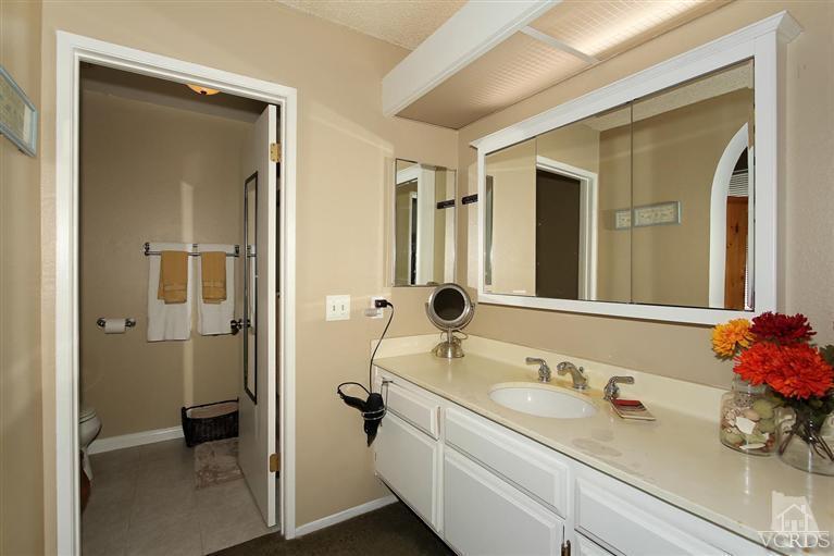 4757 Avedon Road Moorpark, CA 93021 - Photo 10 of 22 a bathroom with a sink and mirror with toilet