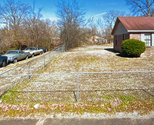 a view of a yard and front view of a house