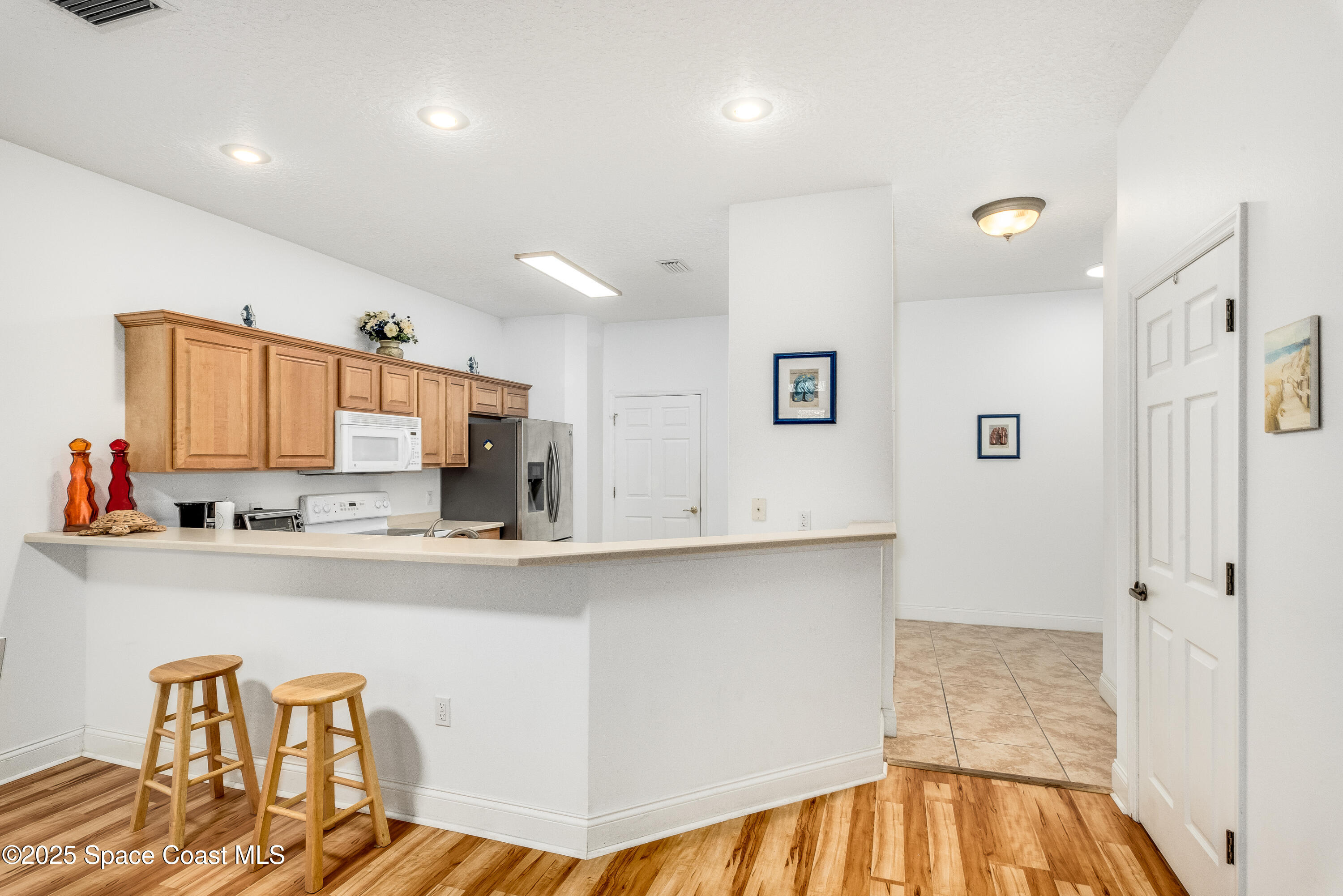 3188 Ricks Way, Unit B Melbourne Beach, FL 32951 - Photo 13 of 58 a kitchen with stainless steel appliances a sink and a refrigerator
