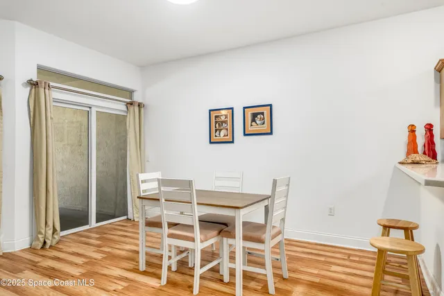 a living room with wooden floor furniture and a window