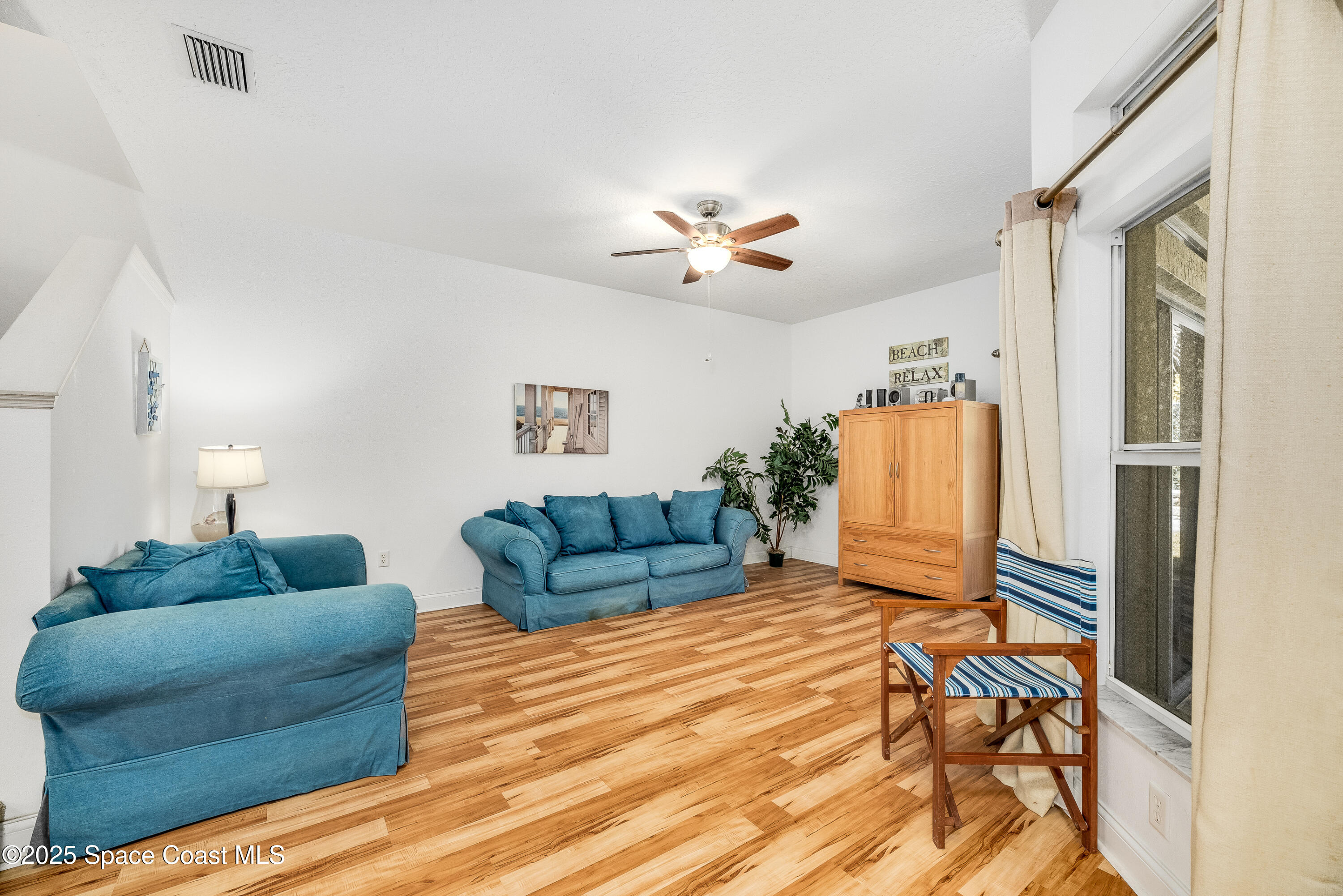 3188 Ricks Way, Unit B Melbourne Beach, FL 32951 - Photo 15 of 58 a living room with furniture and a wooden floor