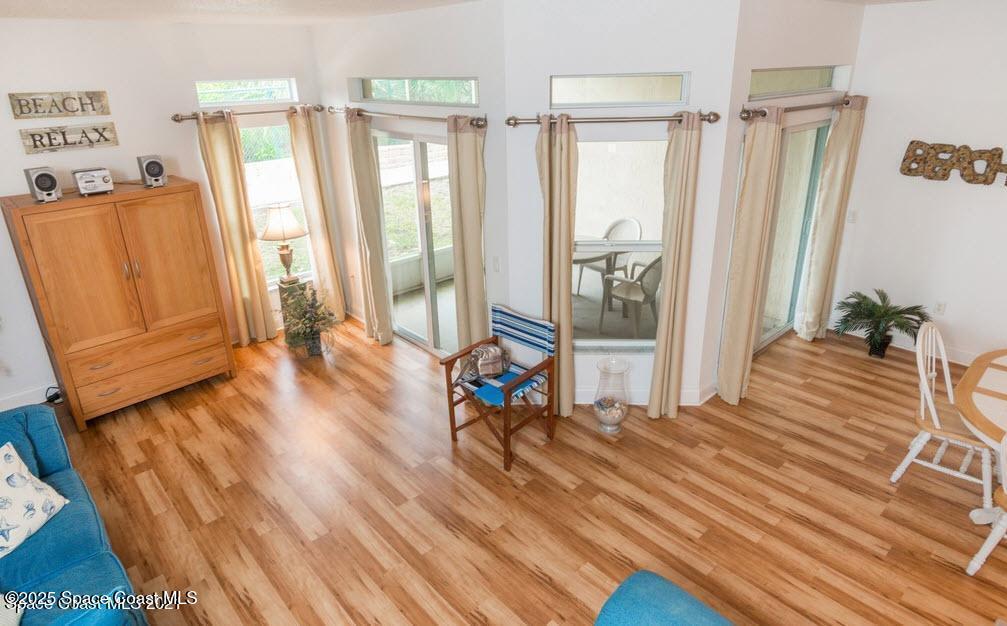 3188 Ricks Way, Unit B Melbourne Beach, FL 32951 - Photo 16 of 58 a living room with wooden floor furniture and a window
