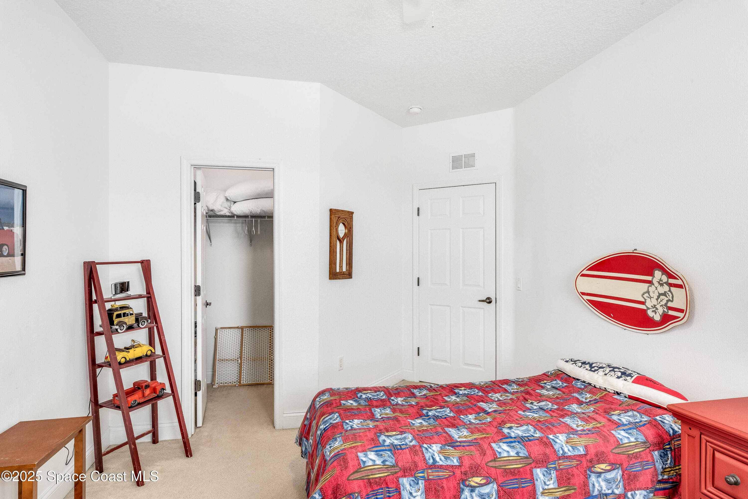 3188 Ricks Way, Unit B Melbourne Beach, FL 32951 - Photo 21 of 58 a bedroom with a bed and a dresser