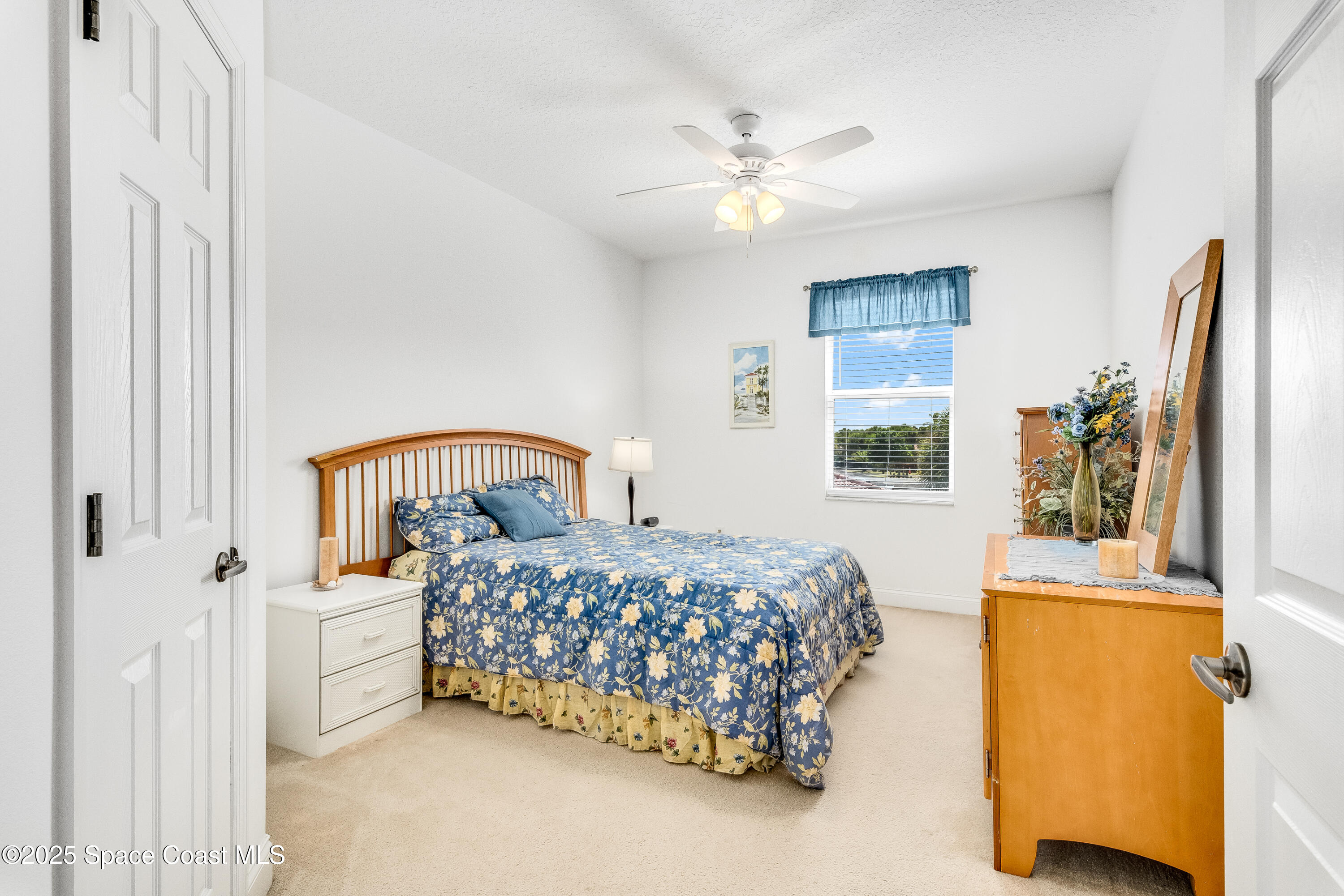 3188 Ricks Way, Unit B Melbourne Beach, FL 32951 - Photo 22 of 58 a bedroom with a bed and a chandelier