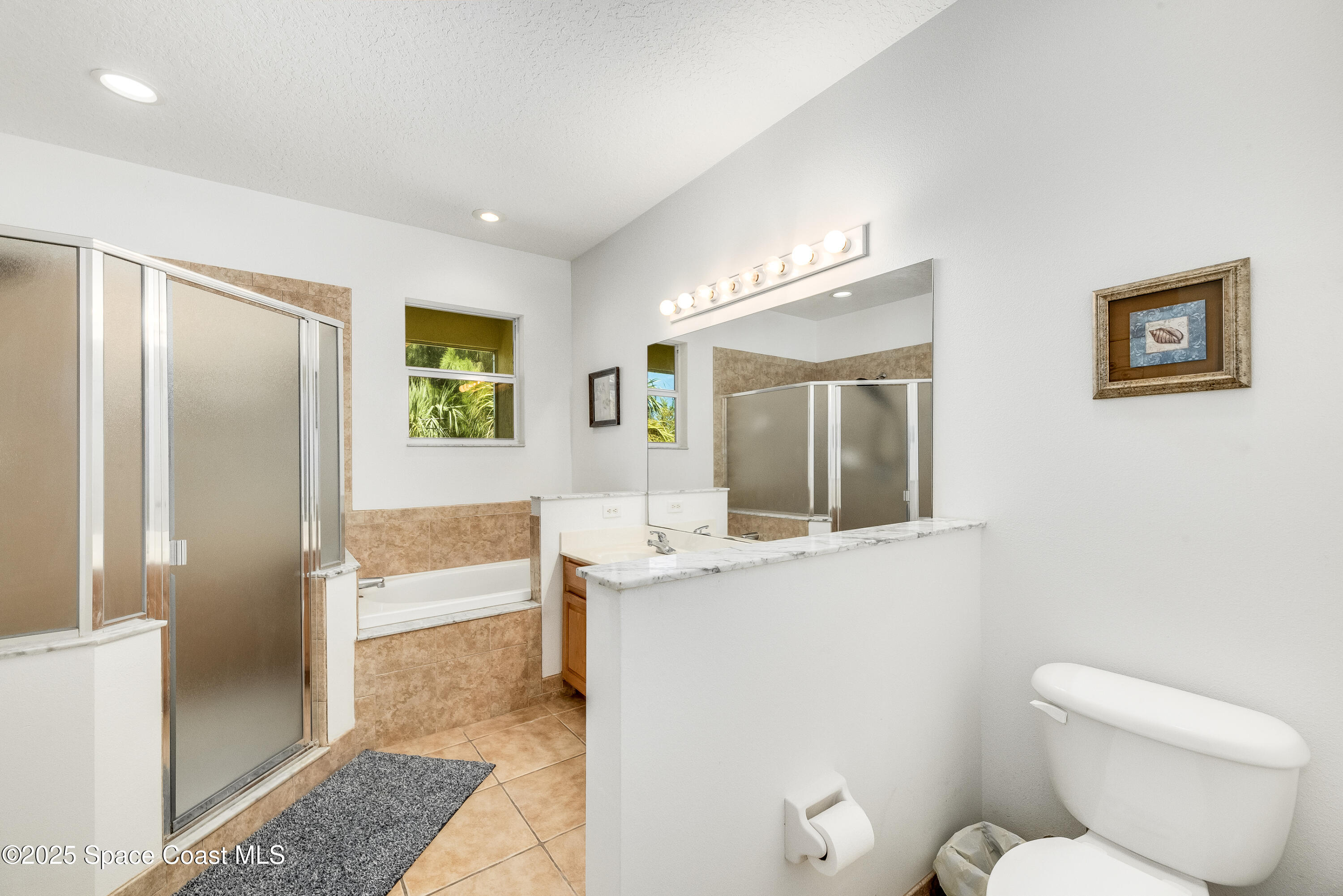 3188 Ricks Way, Unit B Melbourne Beach, FL 32951 - Photo 30 of 58 a view of bathroom with a toilet sink and mirror