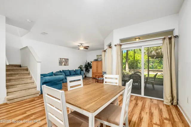 a living room with furniture and a large window with wooden floor