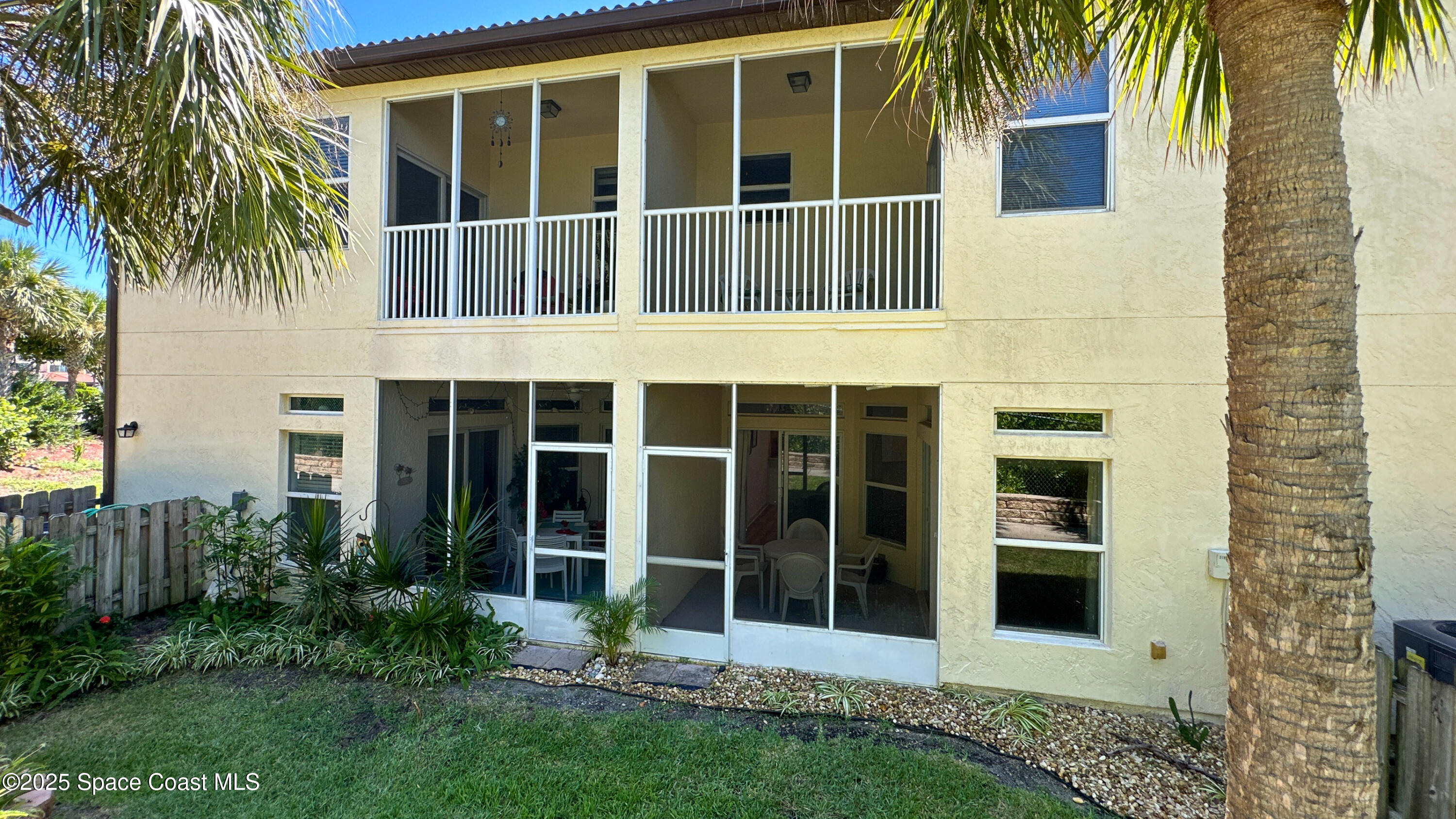 3188 Ricks Way, Unit B Melbourne Beach, FL 32951 - Photo 37 of 58 a view of a house with a window and palm trees