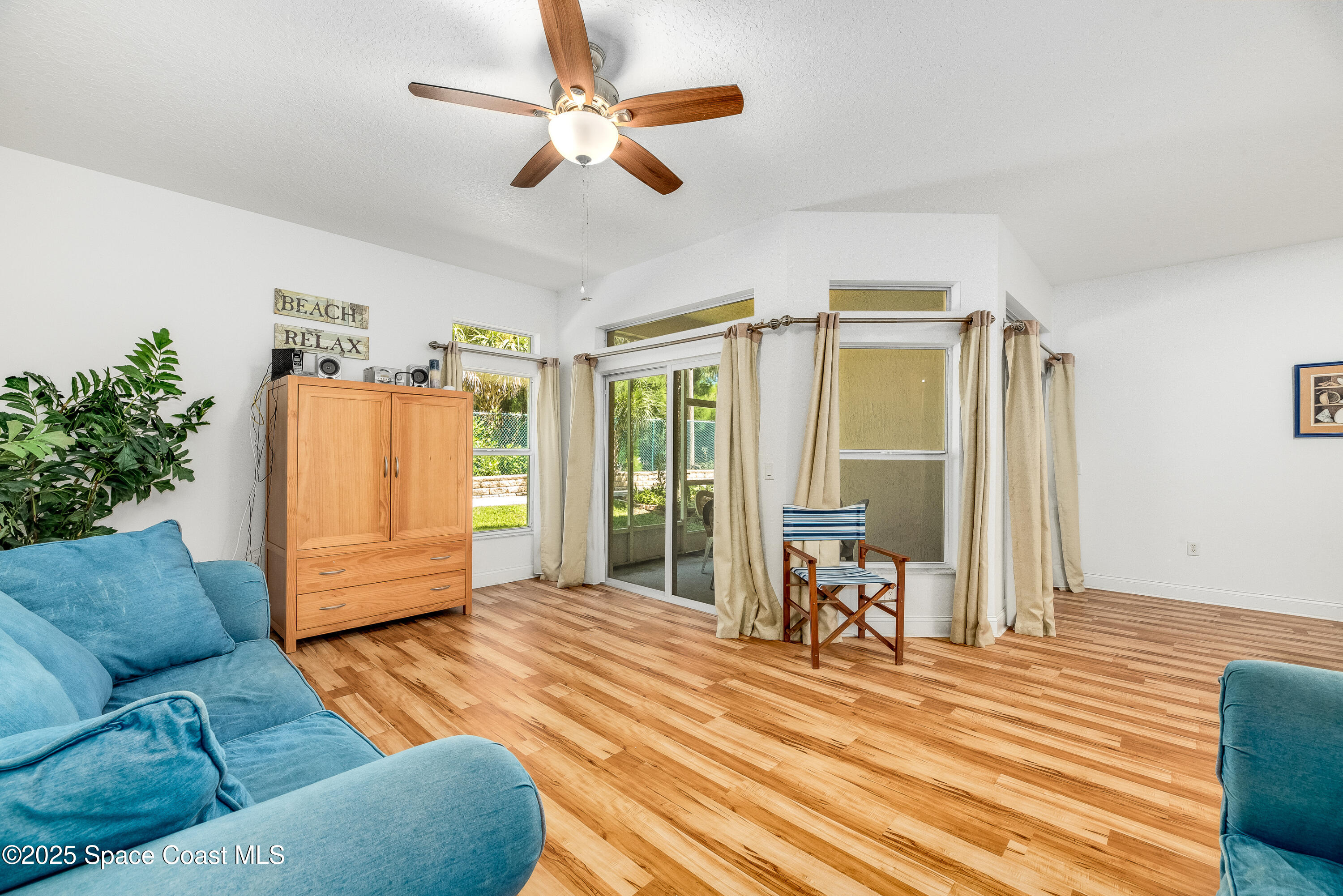 3188 Ricks Way, Unit B Melbourne Beach, FL 32951 - Photo 4 of 58 a living room with furniture and a large window with wooden floor