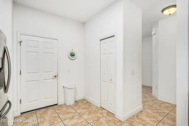 a kitchen with a refrigerator sink and cabinets