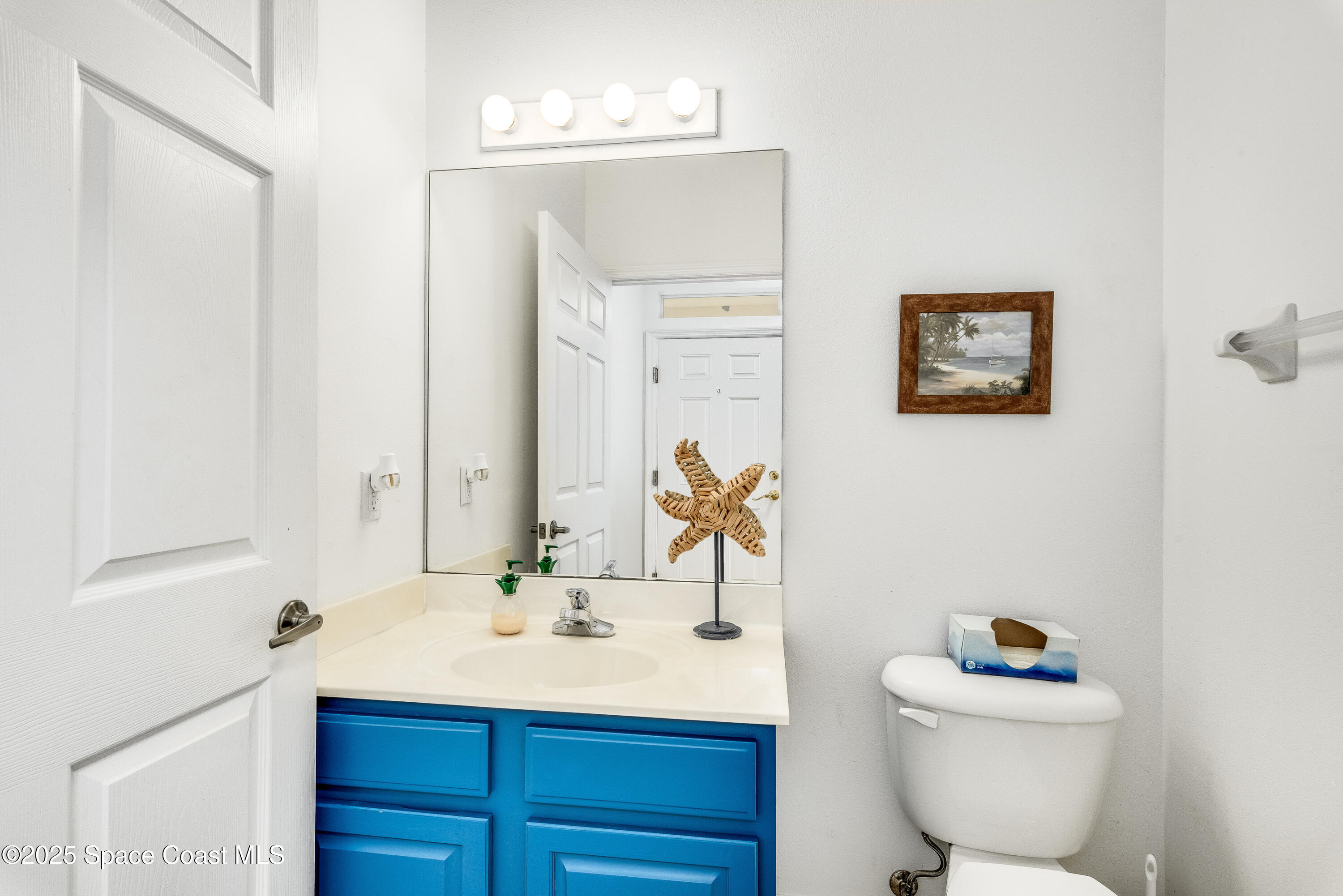 3188 Ricks Way, Unit B Melbourne Beach, FL 32951 - Photo 9 of 58 a bathroom with a sink mirror vanity and toilet