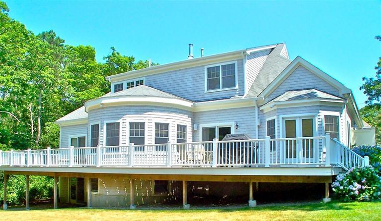 7 Aunt Janes Road Mashpee, MA 02649 - Photo 1 of 14 a front view of a house with a yard