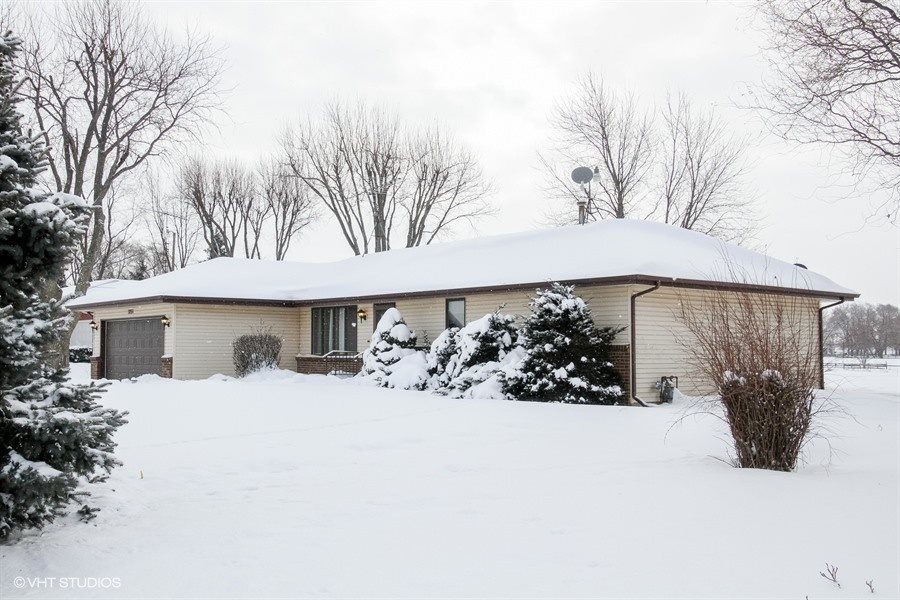 1851 Ipsen Road Belvidere, IL 61008 - Photo 1 of 14 a front view of a house with a yard covered in snow