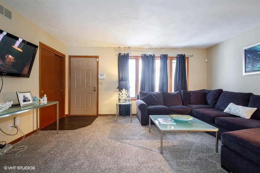 1851 Ipsen Road Belvidere, IL 61008 - Photo 3 of 14 a living room with furniture a flat screen tv and a window