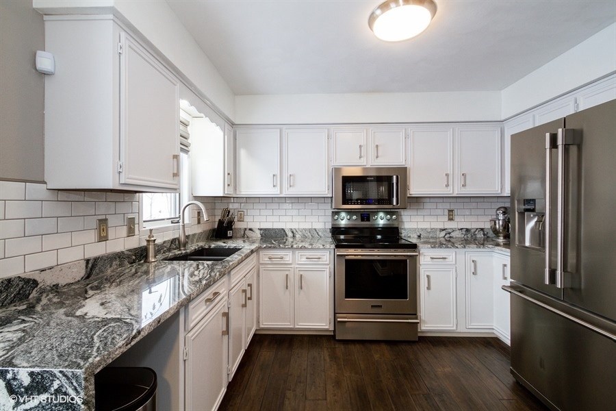 1851 Ipsen Road Belvidere, IL 61008 - Photo 6 of 14 a kitchen with stainless steel appliances granite countertop a sink stove microwave and refrigerator