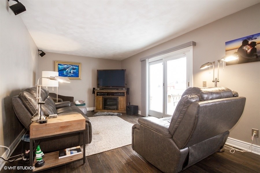 1851 Ipsen Road Belvidere, IL 61008 - Photo 9 of 14 a living room with furniture a window and a flat screen tv