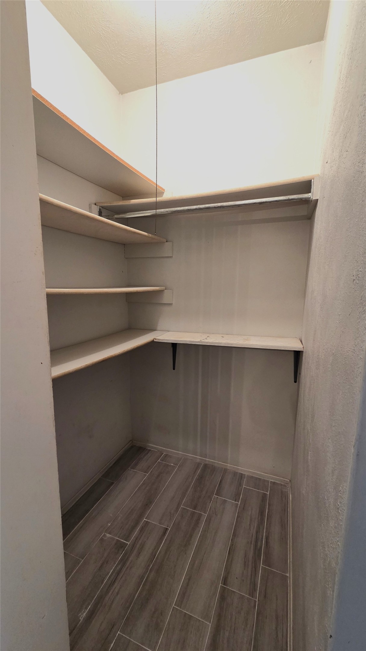 14110 Pinewest Drive Houston, TX 77049 - Photo 13 of 26 a view of walk in closet with empty racks