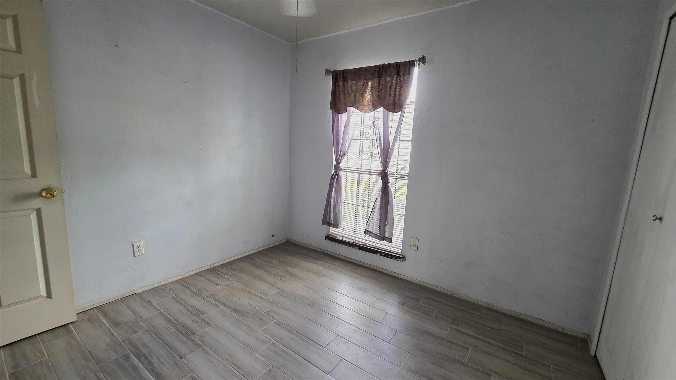 14110 Pinewest Drive Houston, TX 77049 - Photo 16 of 26 an empty room with wooden floor and windows