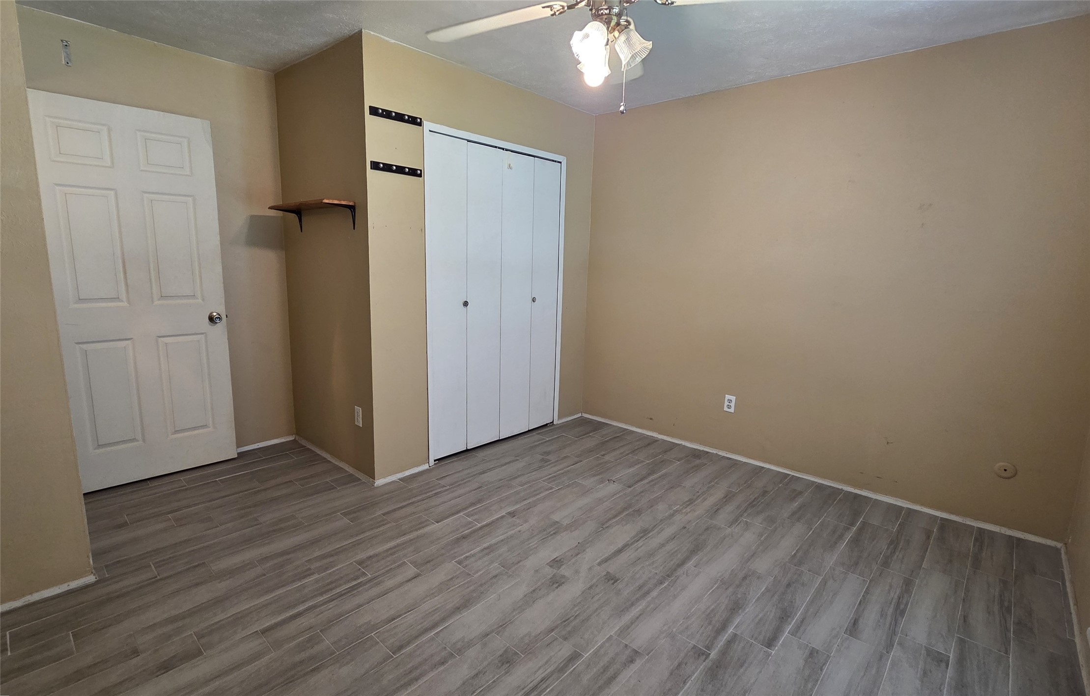 14110 Pinewest Drive Houston, TX 77049 - Photo 18 of 26 a view of an empty room with wooden floor