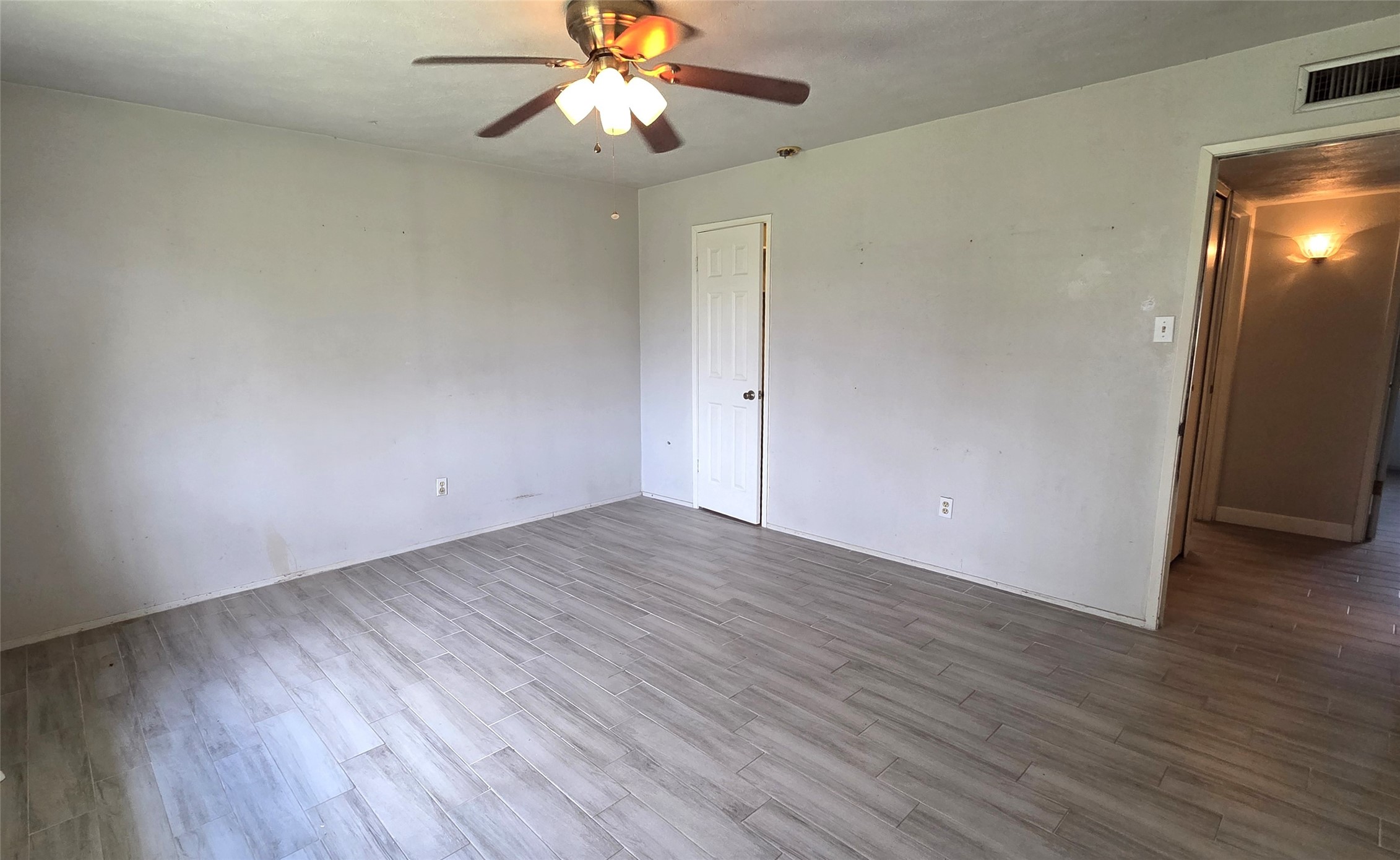 14110 Pinewest Drive Houston, TX 77049 - Photo 22 of 26 an empty room with wooden floor and windows