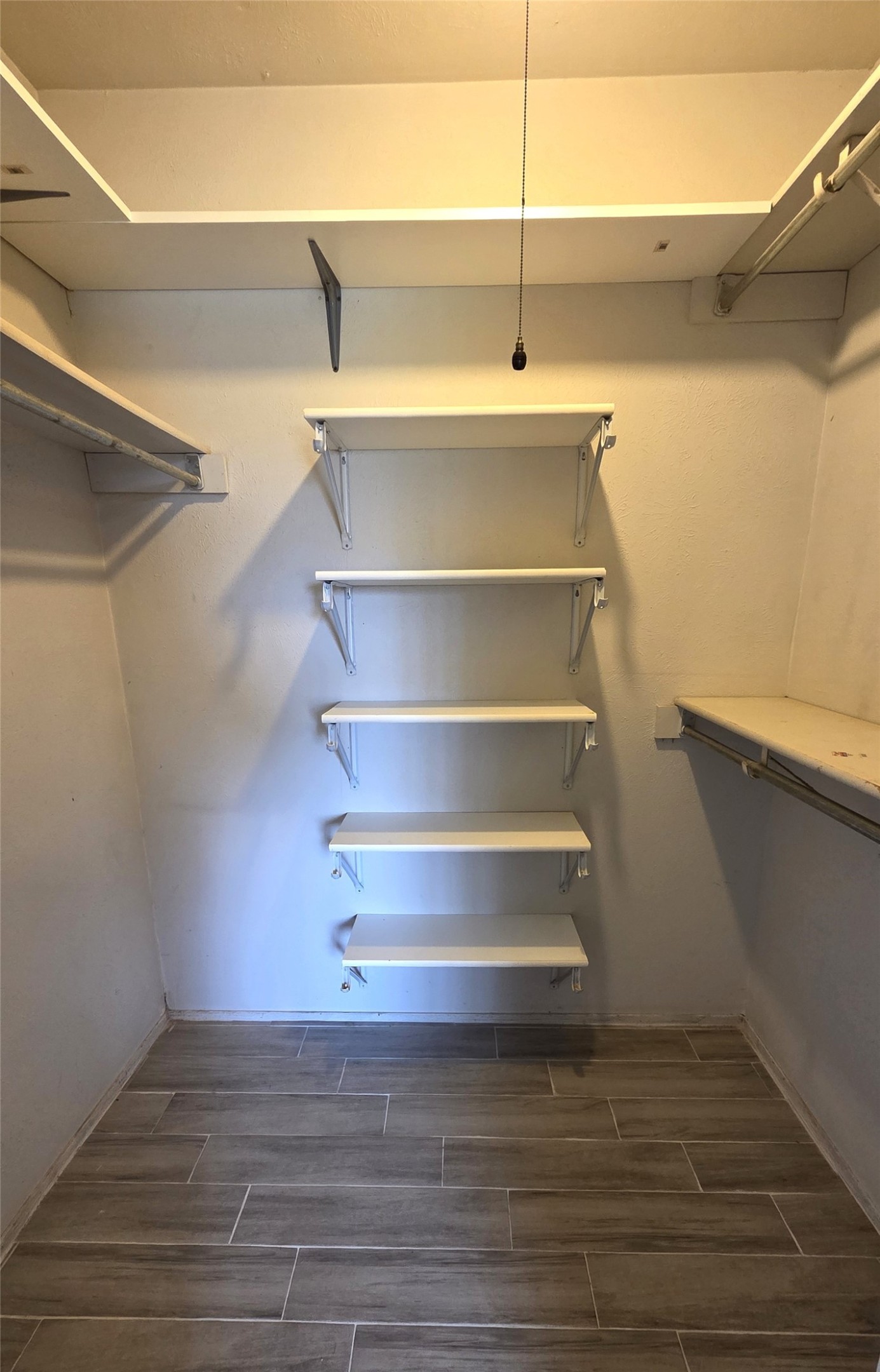 14110 Pinewest Drive Houston, TX 77049 - Photo 23 of 26 a view of walk in closet with empty racks