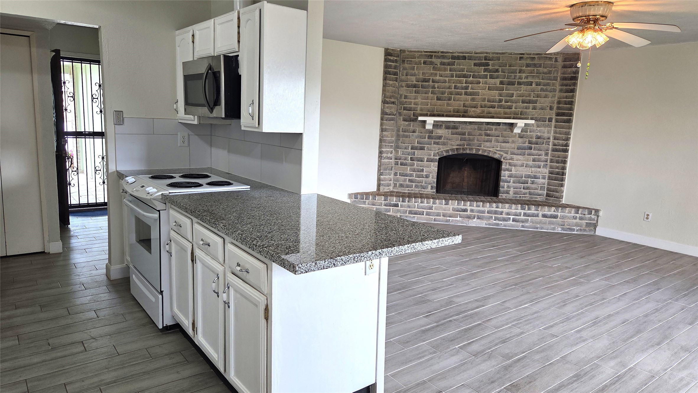 14110 Pinewest Drive Houston, TX 77049 - Photo 7 of 26 a kitchen with granite countertop a sink and a stove top oven