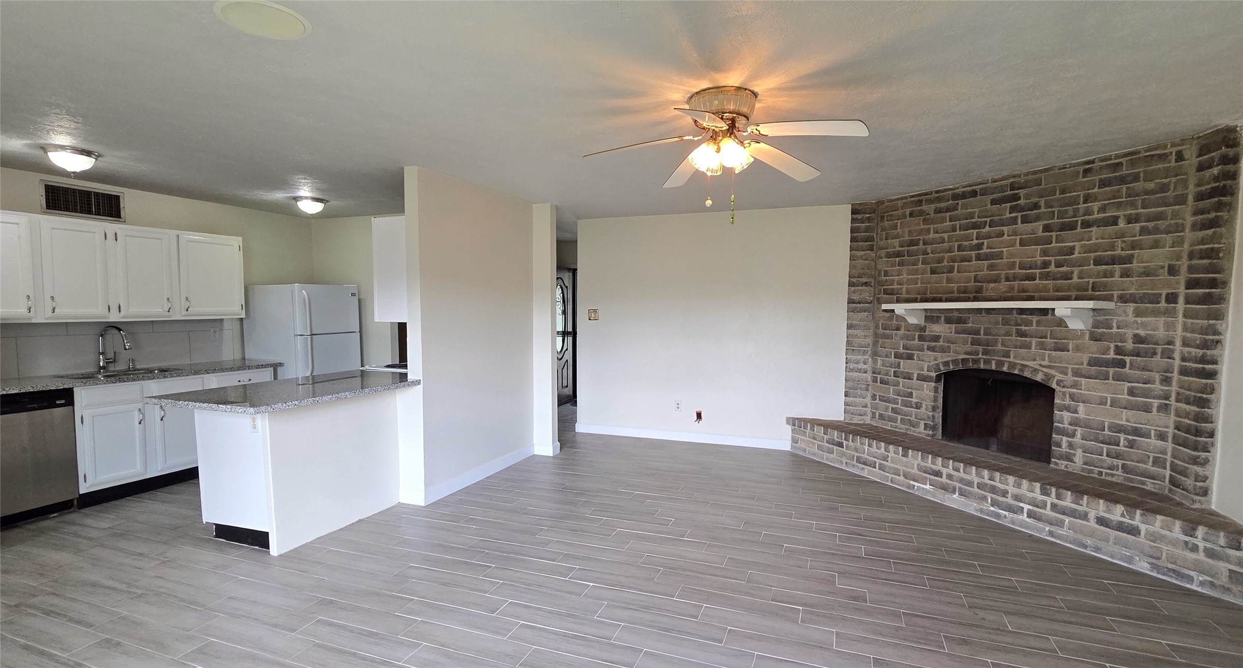 14110 Pinewest Drive Houston, TX 77049 - Photo 8 of 26 a living room with stainless steel appliances granite countertop a fireplace