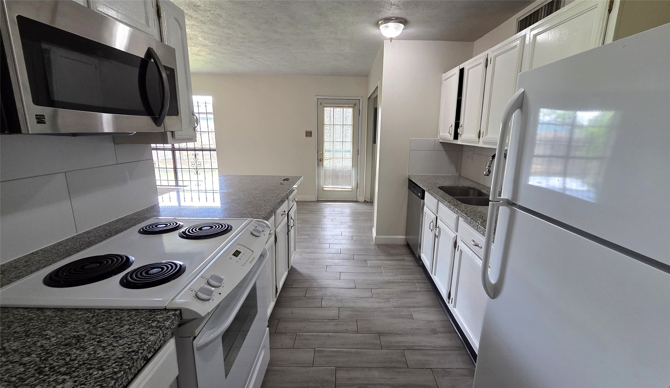 14110 Pinewest Drive Houston, TX 77049 - Photo 9 of 26 a kitchen with a stove and a microwave