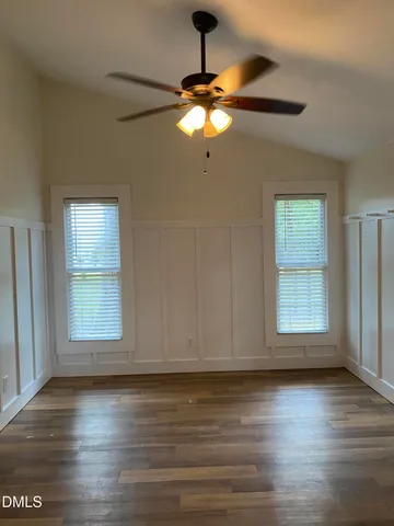 a view of a room with wooden floor and windows