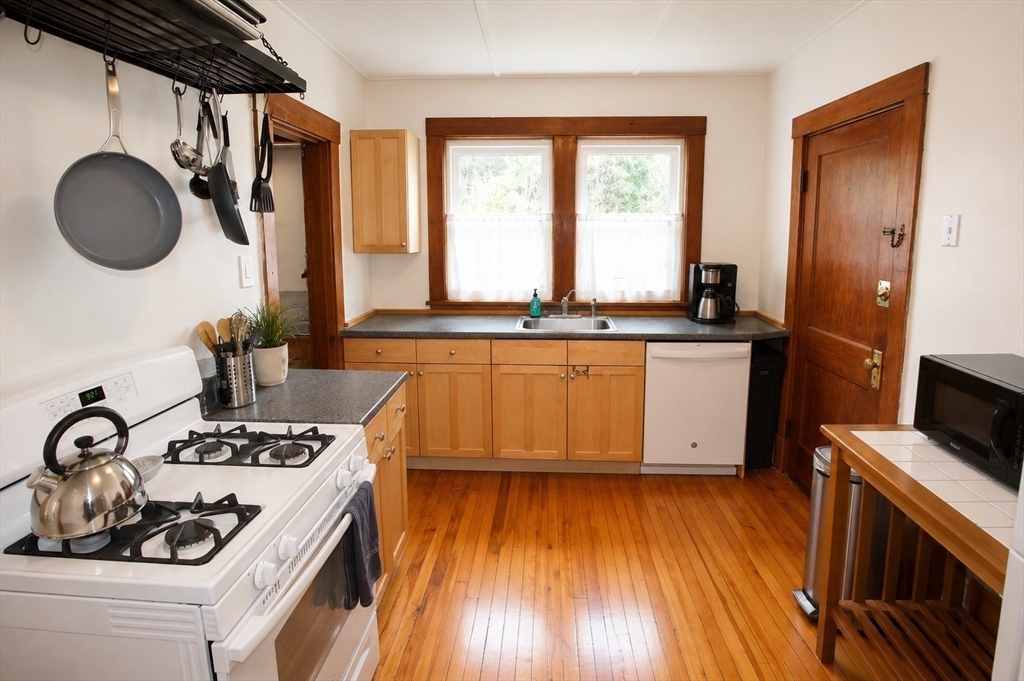 15 Herbert Road, Unit 15 Arlington, MA 02474 - Photo 6 of 9 a kitchen with wooden floors and sink