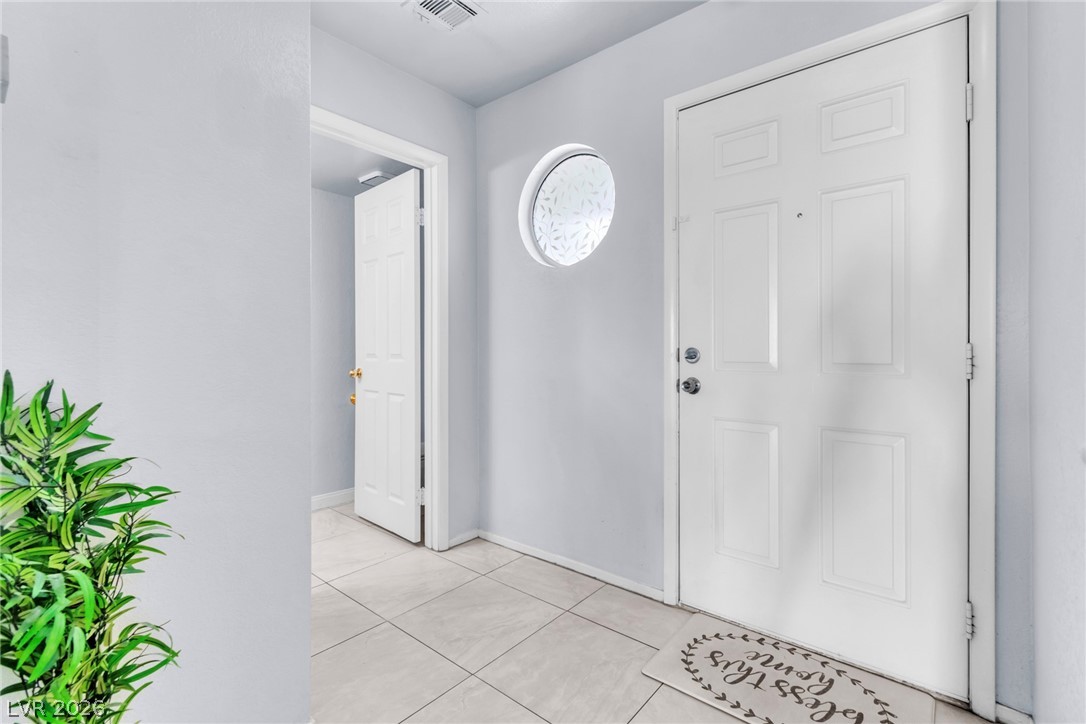 6250 West Flamingo Road, Unit 98 Las Vegas, NV 89103 - Photo 2 of 40 Entrance foyer featuring light tile patterned floors, baseboards, and visible vents
