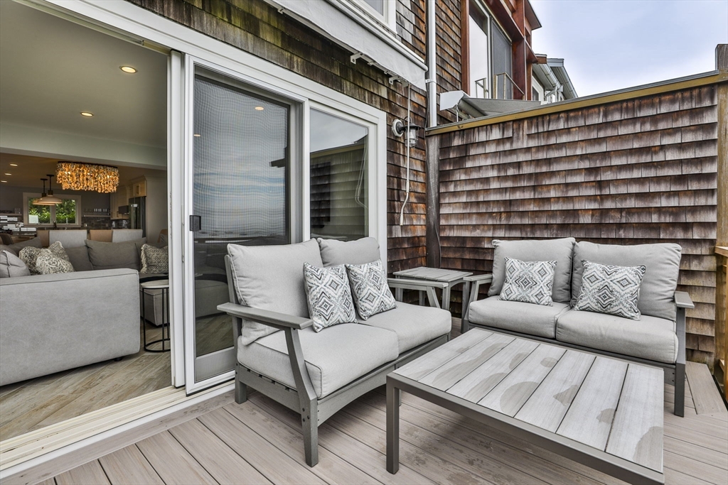 45 Raymond Street, Unit 7 Manchester, MA 01944 - Photo 14 of 40 a balcony with furniture and wooden floor