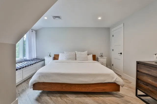 a spacious bedroom with a bed and cabinets