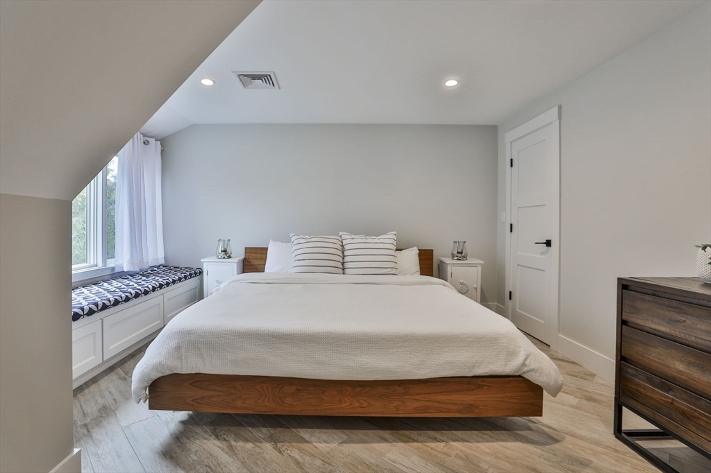 45 Raymond Street, Unit 7 Manchester, MA 01944 - Photo 15 of 40 a spacious bedroom with a bed and cabinets