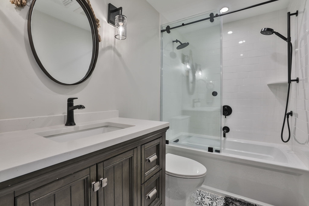 45 Raymond Street, Unit 7 Manchester, MA 01944 - Photo 16 of 40 a bathroom with a sink a toilet and a mirror