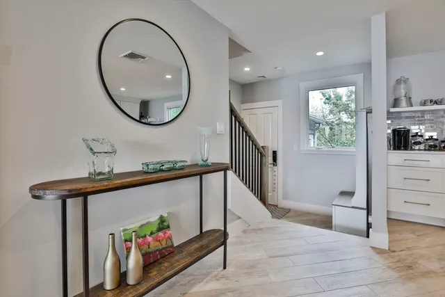a view of a hallway with wooden floor and entryway