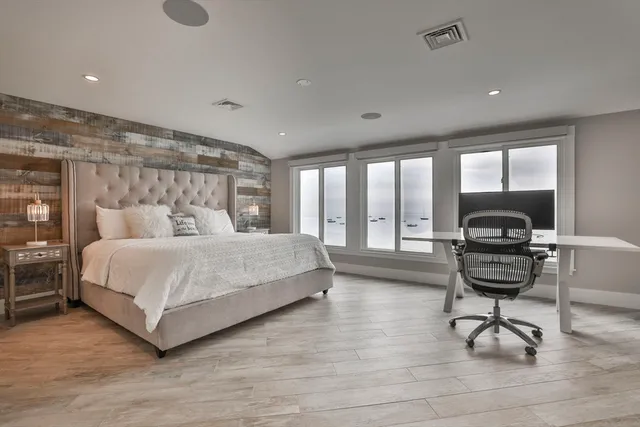 a bedroom with a bed and a desk